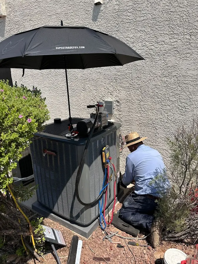 HVAC technician performing outdoor AC maintenance in Forest Acres